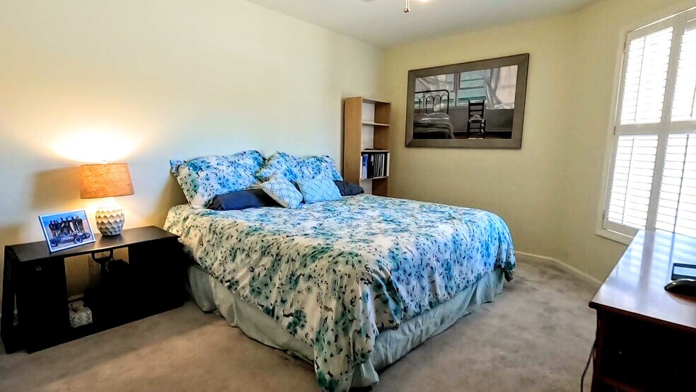 Guest bedroom with new carpet and walk-in closet, located off main living area directly across. - 424 Commerce Ave