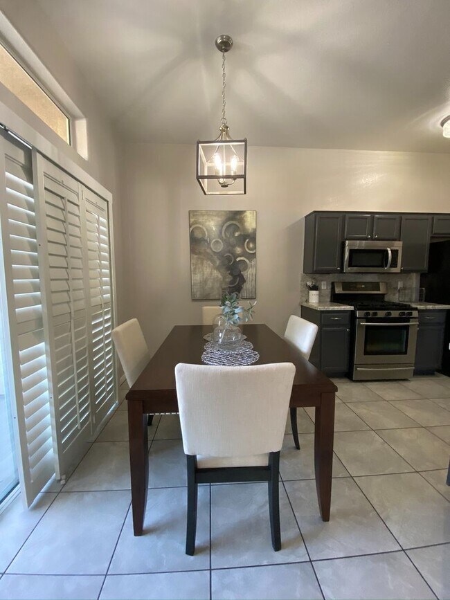 Building Photo - BEAUTIFUL CONDO IN A GATED COMMUNITY FEATURING PLANTATION SHUTTERS, TILE FLOORING AND NEW PAINT T...