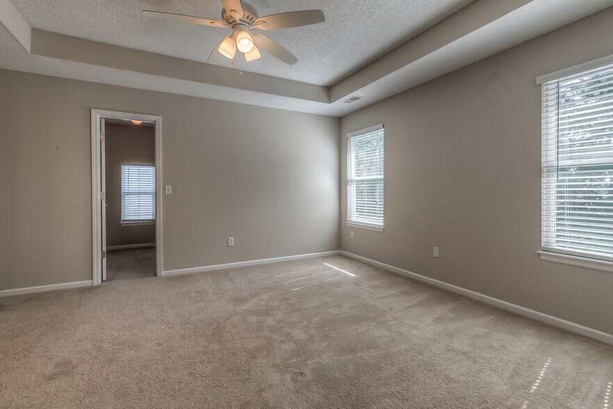 master bedroom with vault and ceiling fan - 22810 West 71st Terrace