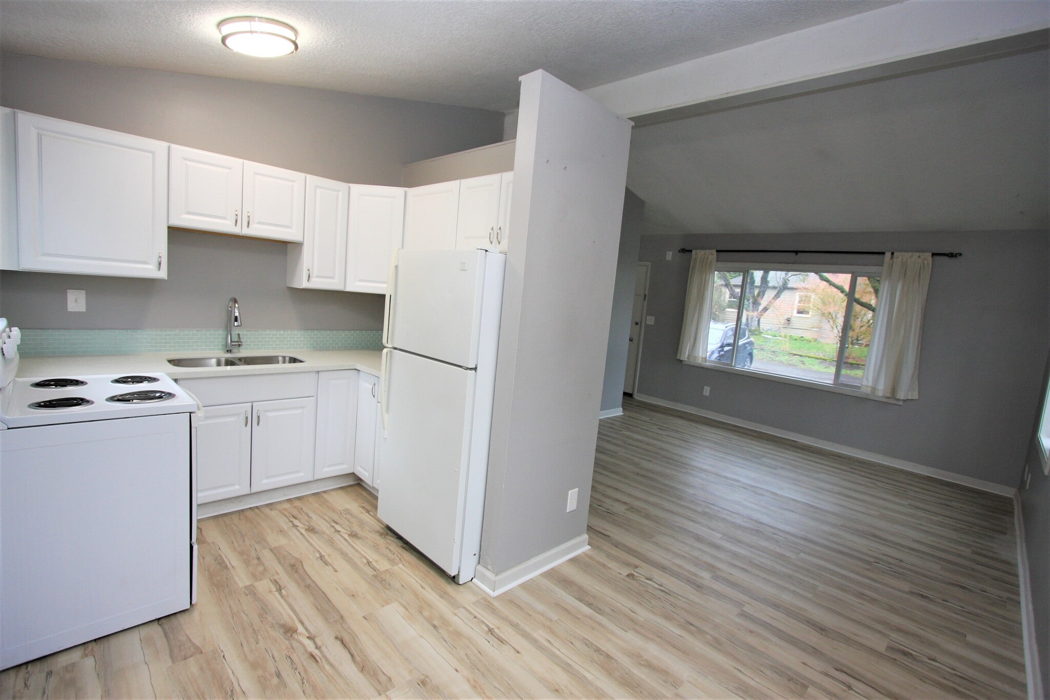Kitchen with newer cabinets and brand new quartz counters, undermount sink and new faucet. - 5442 -5448 SE Franklin St