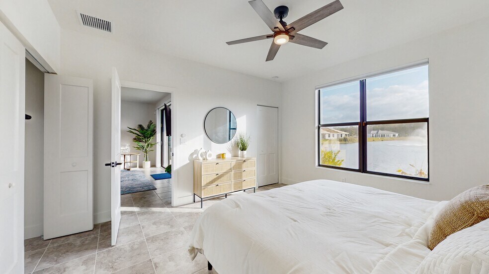 Primary bedroom King size bed with water view - 13071 Georges Cay Pl