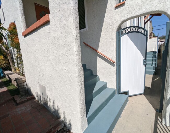 White gate opens near front door stairs - 1830 S Curson Ave