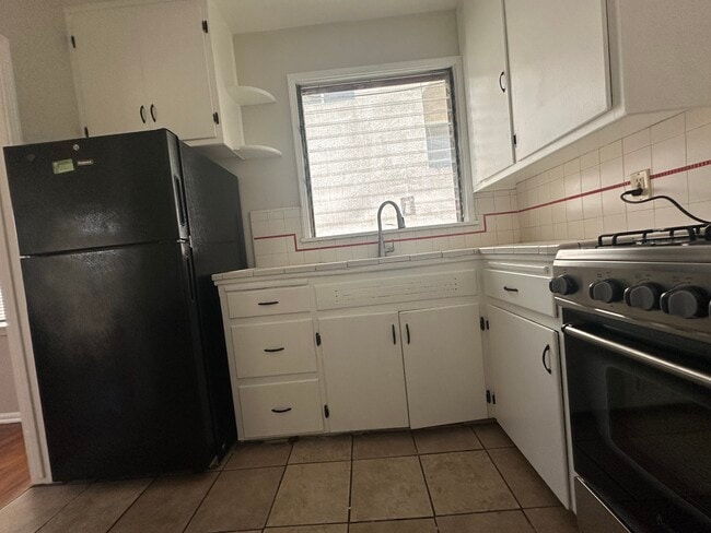 Refrigerator included with the unit. - 5646 Farmdale Ave