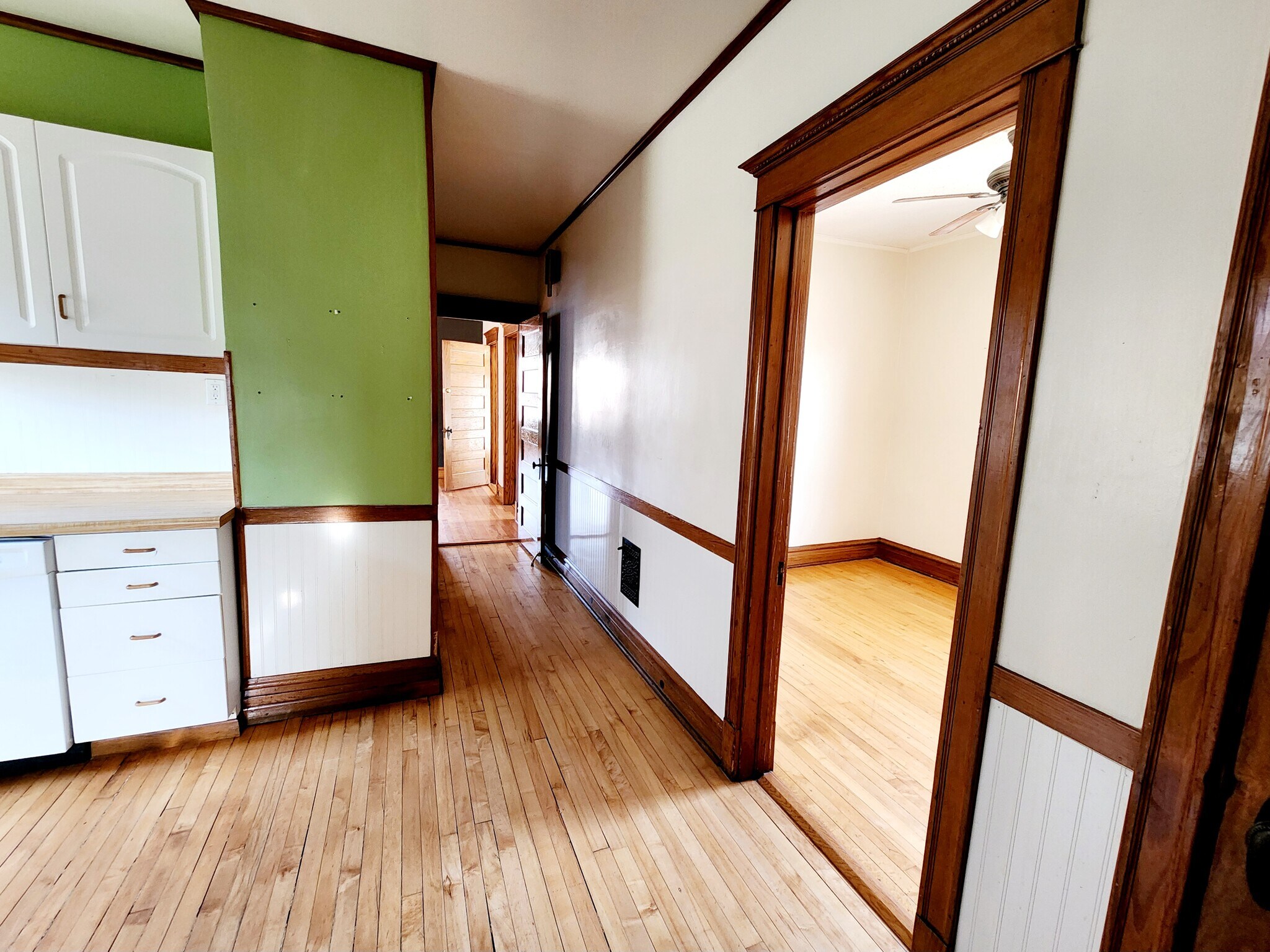 View from kitchen looking west, bedroom on the right and hallway to living spaces - 3747 N Kostner Ave