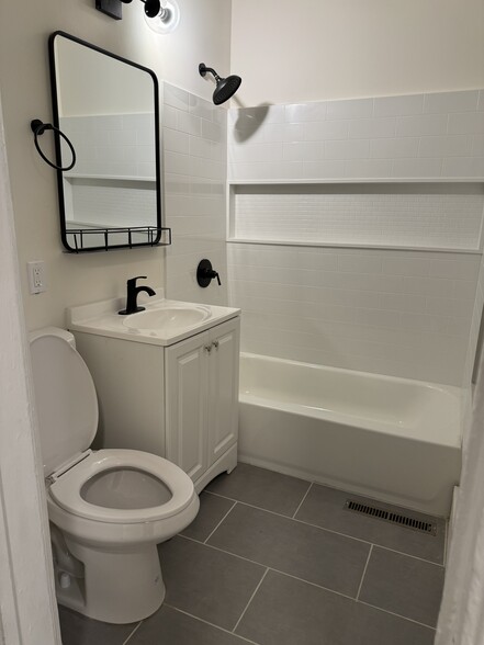 Renovated bath with new tile, shower and vanity - 118 Philip St