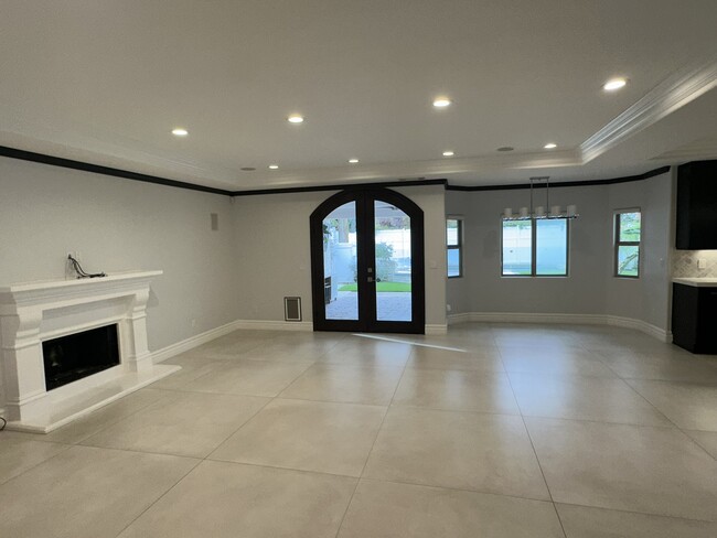 Family room with fireplace & French doors - 4513 Tyrone Ave