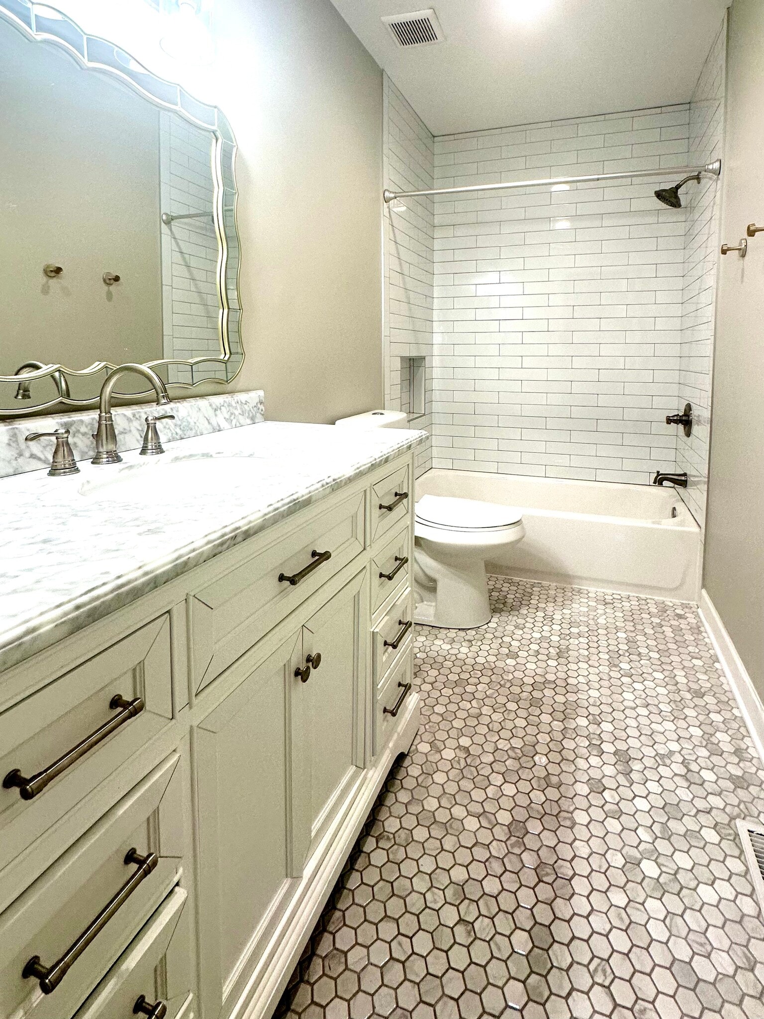Renovated bathroom - combination tub/shower, marble floor tile, lots of storage under sink - 2312 18th Ave S