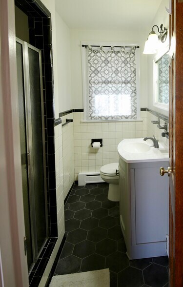 Downstairs bath has shower, new floor and vanity. - 2308 Buckingham Ave