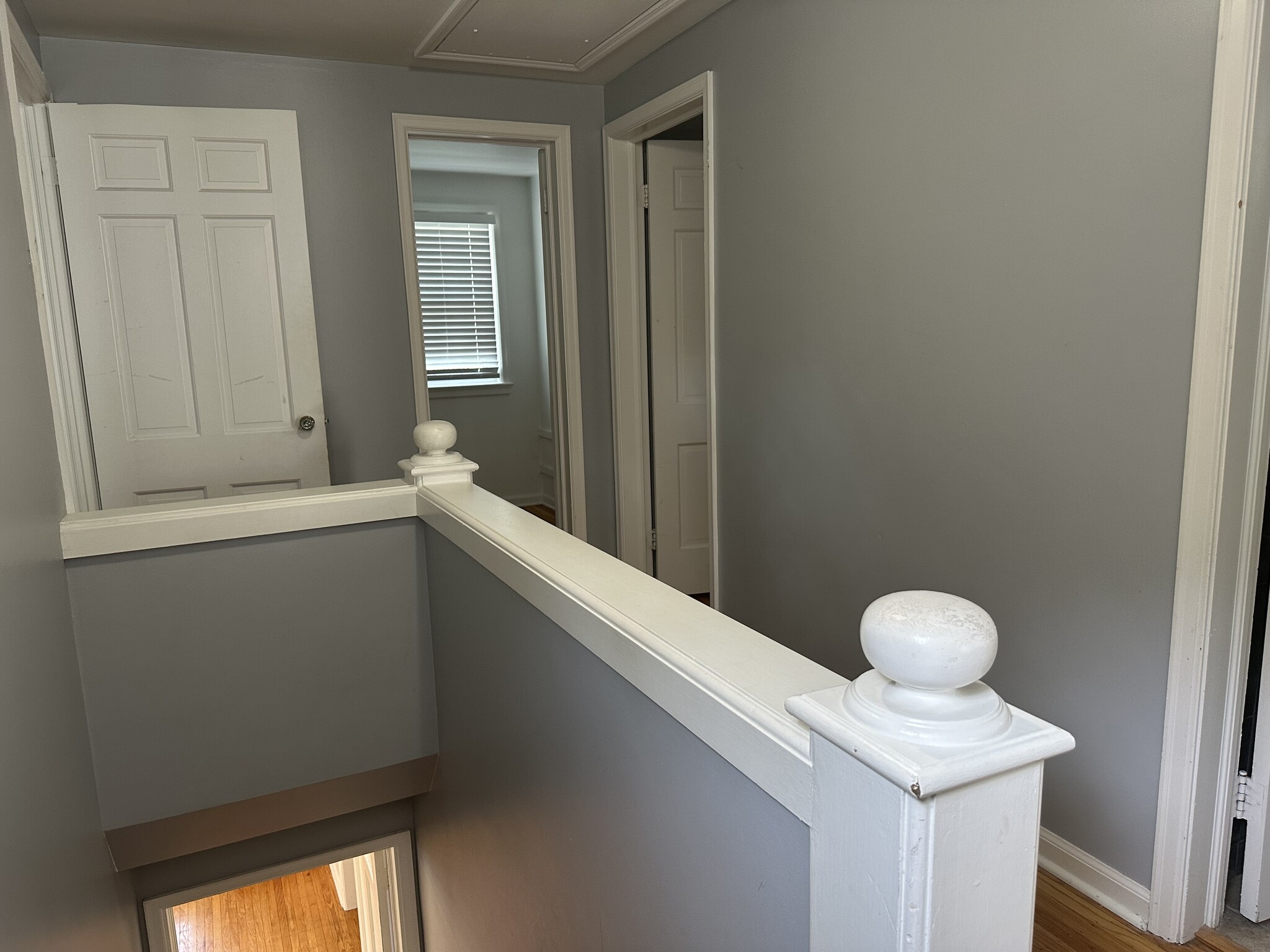 Upstairs hallway with three bedrooms, full bath, and large storage room. - 5101 Boulevard Pl