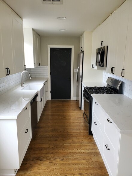 galley style kitchen with door to garage - 8608 Harrison Way