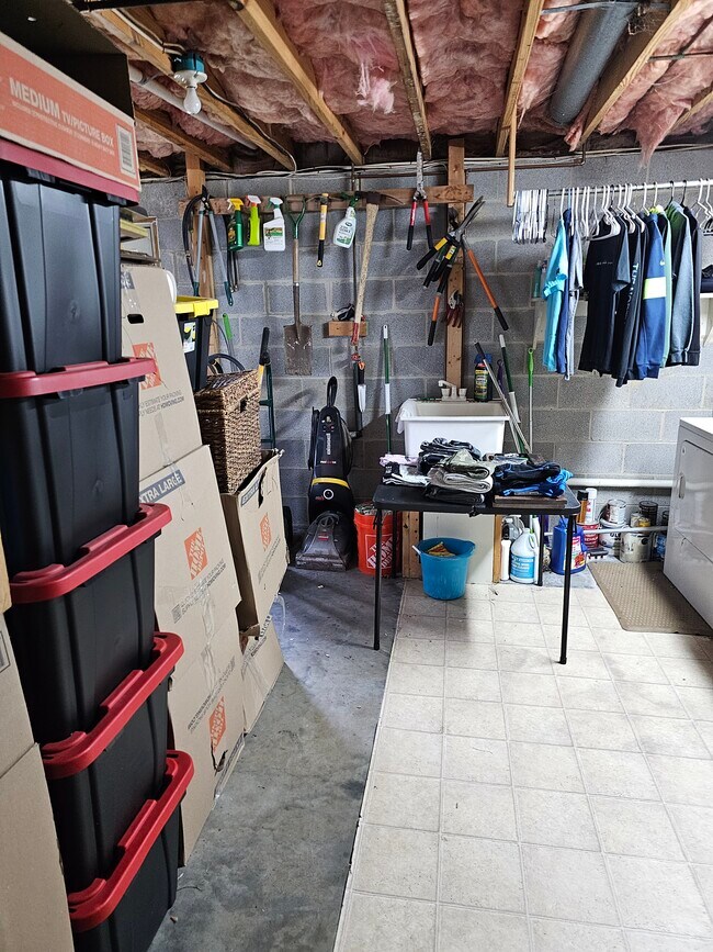 Unfinished side of basement, wet sink, boxes will be gone - 130 Little River Dr