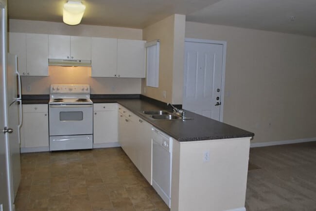 Breakfast bar and partially open kitchen area that is great for entertaining - Bristol Apartment Homes