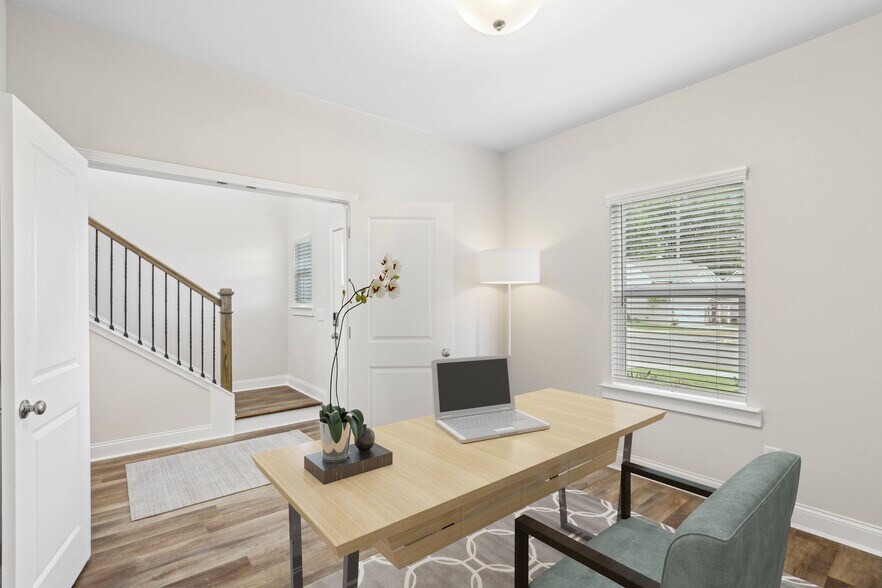 A room with a desk and a laptop on it. - Southwind