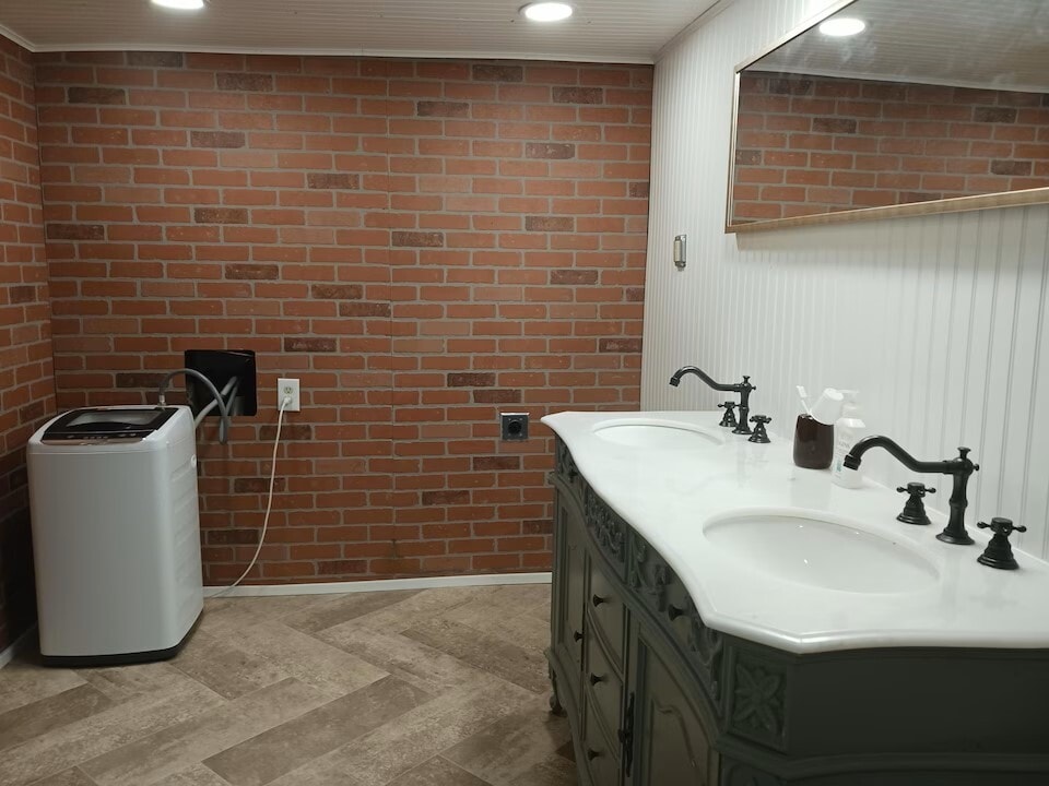 Lower level bathroom with duel sinks. Tub is to left, and door to toilet and an additional sink is a - 814 Atchison Ave