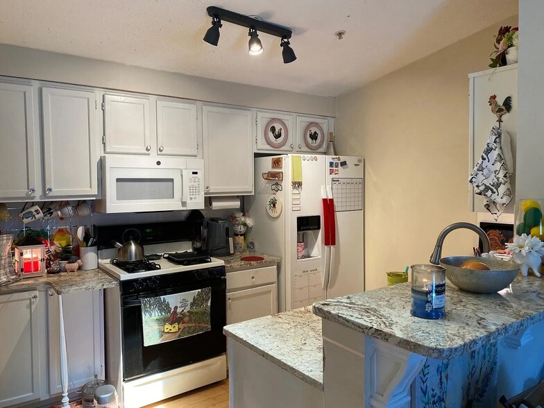 Kitchen with a bar and room for two barstools - 1483 Keys Crossing Dr NE