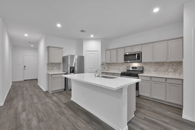 Upgraded countertops throughout and herringbone backsplash in the kitchen. - 15264 Junebug Dr