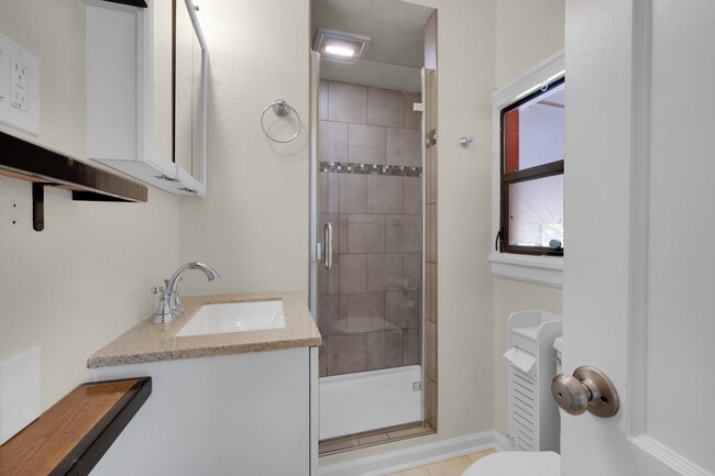 Not one of those icky bathrooms. Nice new, clean surfaces, lots of storage and large shower. - 114 N Foote Ave