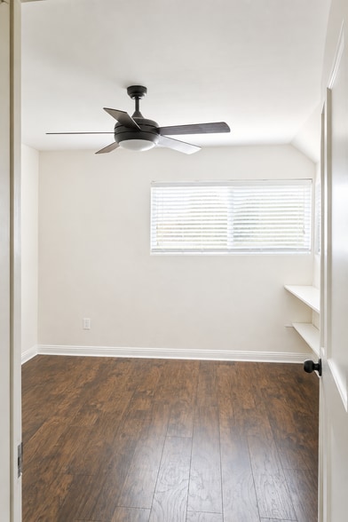 Guest Bedroom: Bright guest room with custom shelving. - 6191 Rancho Mission Rd