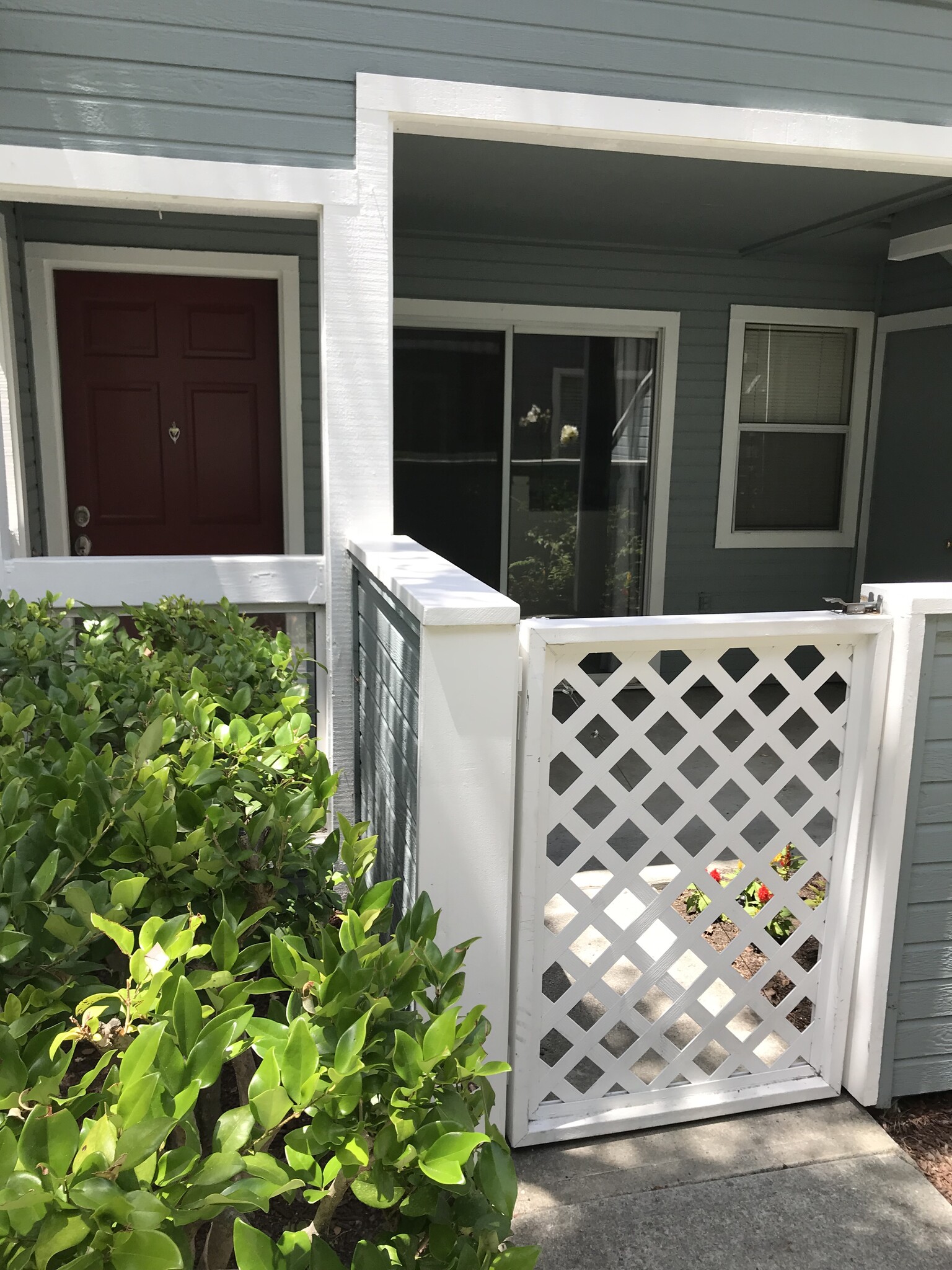 Front front patio, entry door, sliding glass doors, kitchen window - 826 Boardwalk Pl