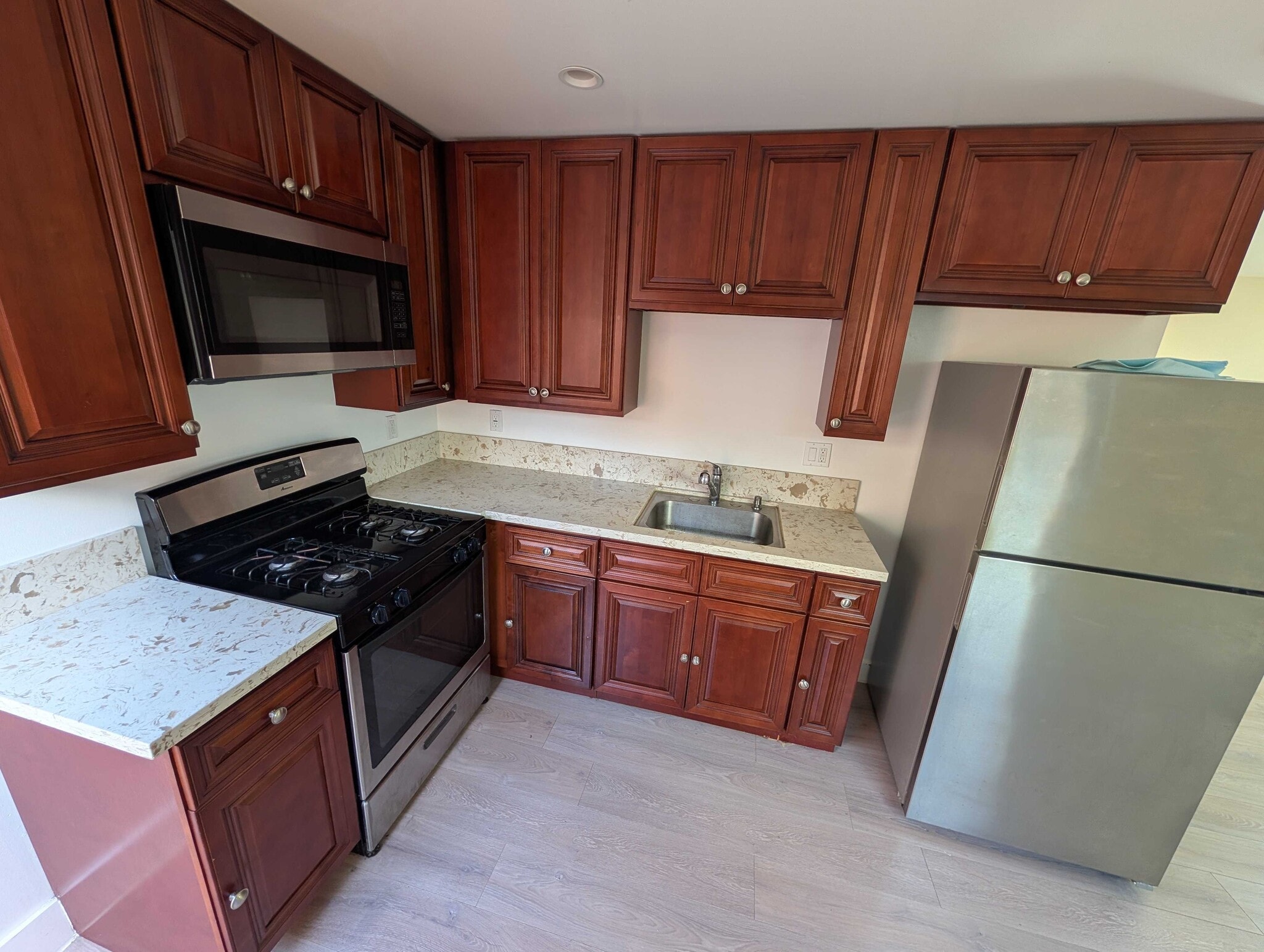 Kitchen with gas range, microwave, and ample cabinet storage - 6534 Peterson Ave