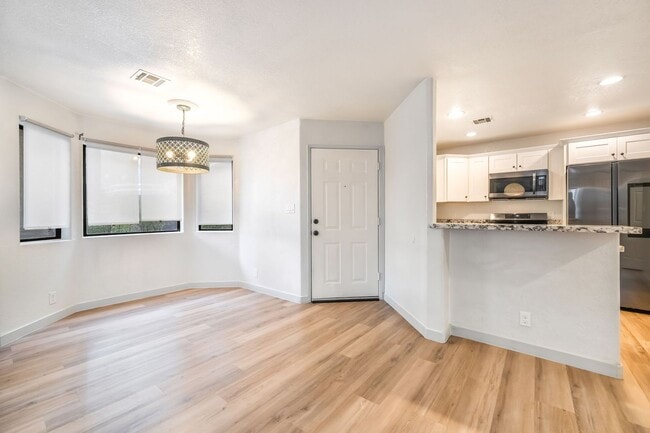 Building Photo - Upgraded Three-Bedroom Condo with Wood Flooring and Modern Comforts!