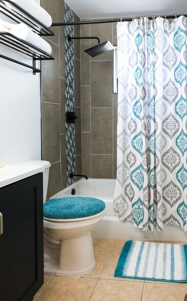 New tile and fixtures. Matching pops of teal to lighten the mood :) - 8612 Echo St