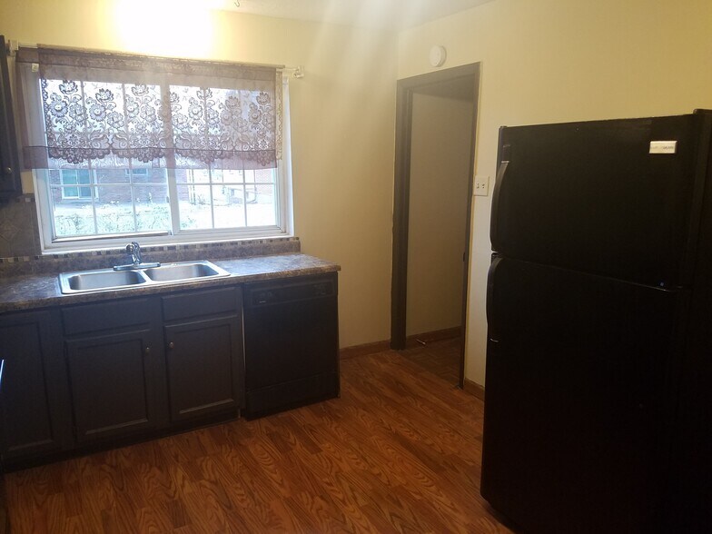 Kitchen has view of large back yard - 1820 Bluebird Dr