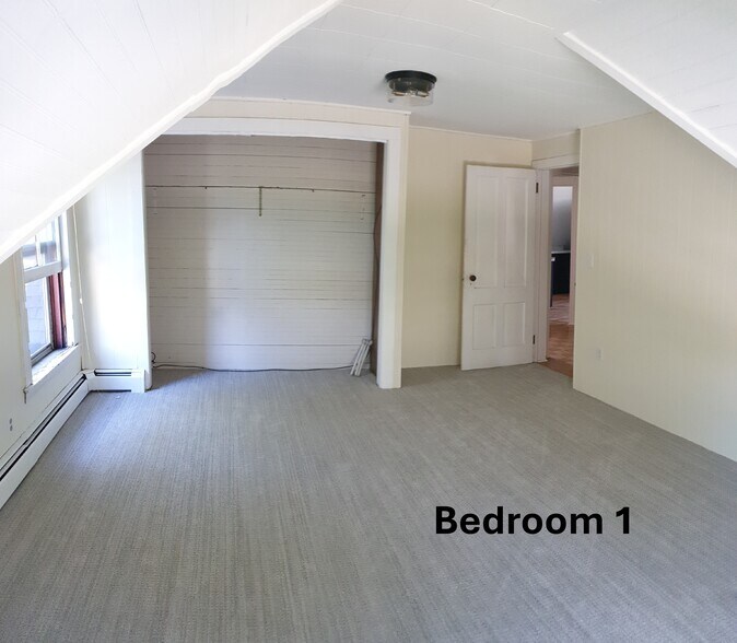 A generously sized bedroom with fresh carpet, two large windows, and plenty of natural light - 412 Morris Ave