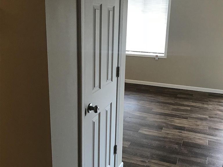 Hallway to living room with pantry closet - 16045 Joplin Ave