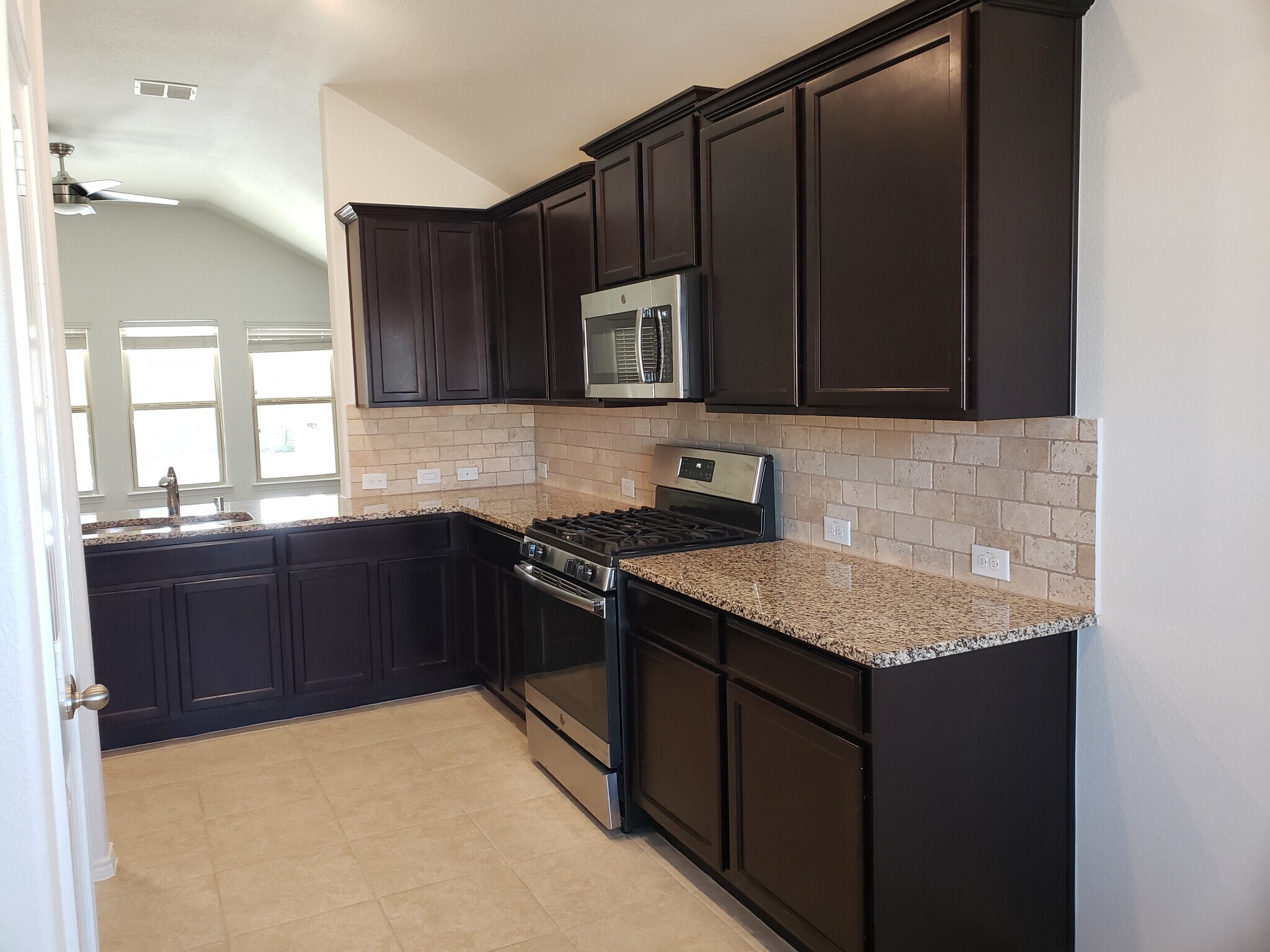 Dark cabinets with pantry and lots of storage. - 14557 Serrano Ridge Rd