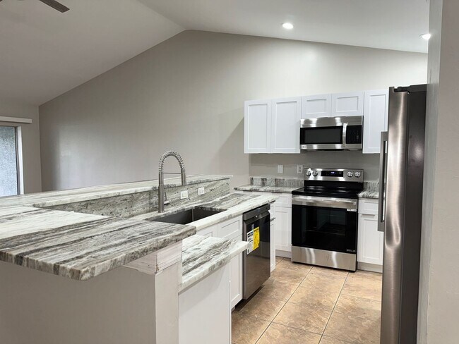 Building Photo - Experience this Cape Coral 3 bedroom 2 bath corner duplex with 1 car garage and screened in lanai.