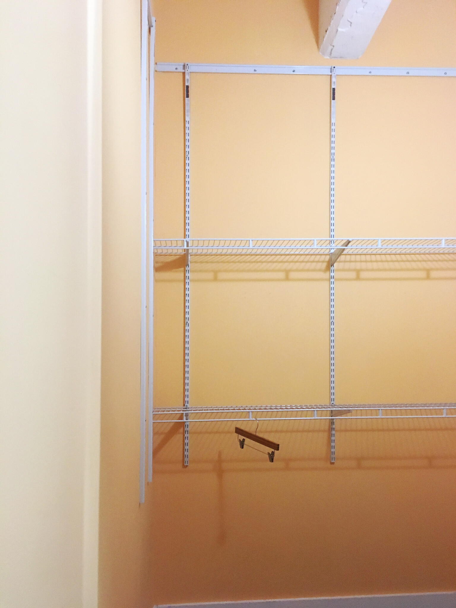 Plenty of tracking on all four walls of the closet makes adding additional shelving or components a breeze. Double-stacked shelves with bars for hanging clothes are mounted on two walls for 20' of shelving and hanging space. - 659 Auburn Ave NE #145