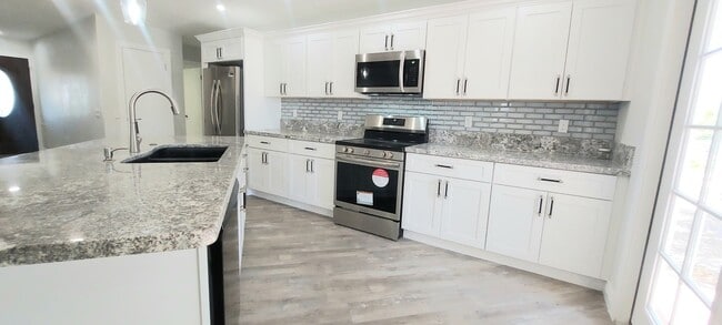 Building Photo - * UTILITIES INCLUDED * TOTALLY REMODELED 2X2