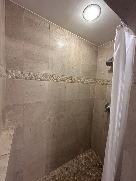 Walk in pebble floor shower - 1111 Van Buren St