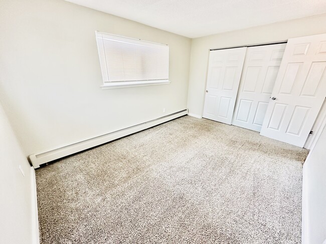 Experience comfort and style in this bright bedroom with ample storage and natural light. - Hawk Point Apartments