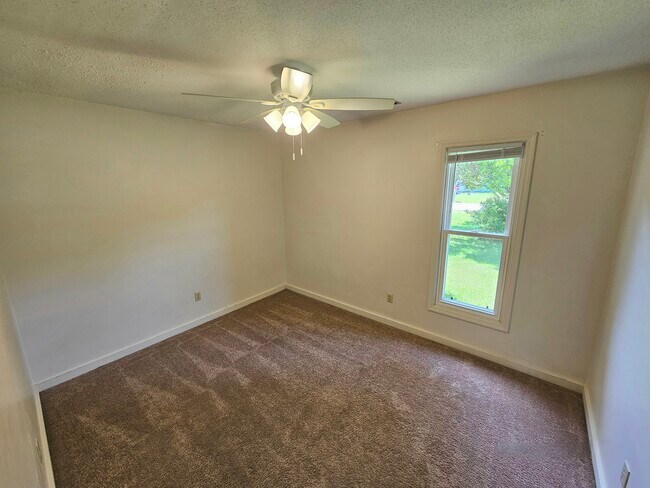 Back bedroom with view of front tree - 404 Rams Rd