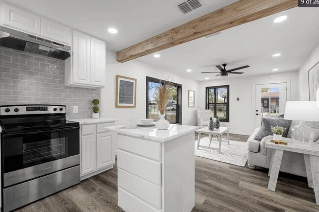 There is a glass top stove and granite counter tops. - 5401 Burton Ln