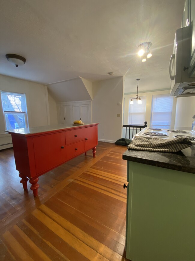 Open kitchen living area with quartz topped vintage island. - 16 Eames St