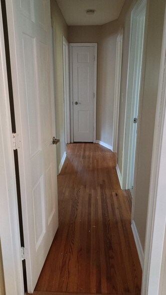 Hallway to 3 bedrooms and bathroom - 907 County Road B W