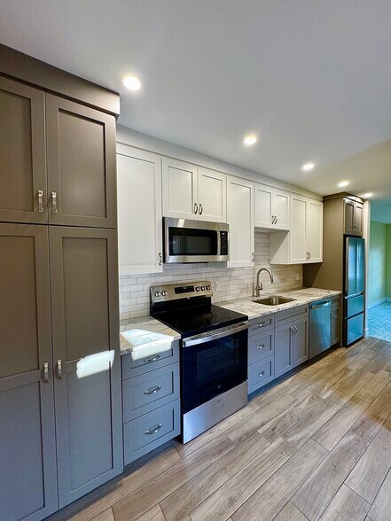 Beautiful galley style kitchen with custom cabinetry with marble countertops - 136 E King St