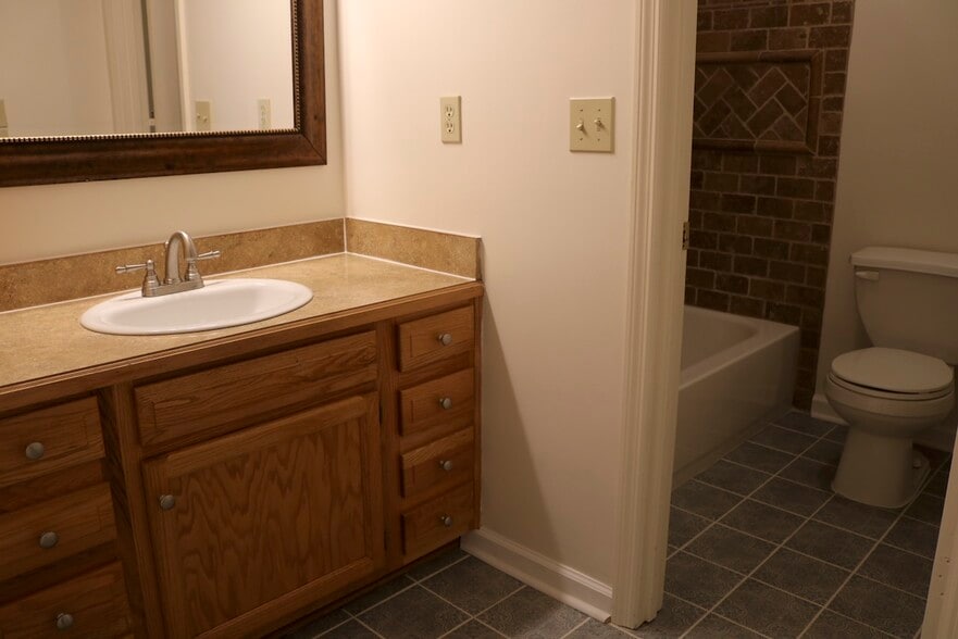 Bath 2 with custom cabinetry and brightly lit. - 7005 Sand Wedge Cir