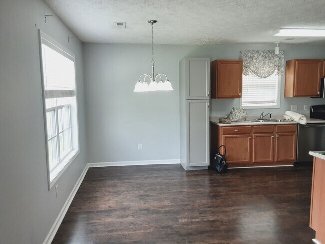 Building Photo - 1/2 off First Month Rent home has new flooring throughout.