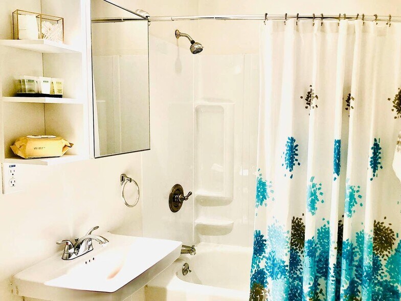 First bathroom with a bathtub and shower - 621 W 43rd St