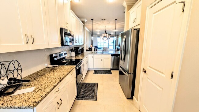 Building Photo - Seasonal/short term turnkey furnished Incredible 2/2 with den ground floor condo in resort Esplan...
