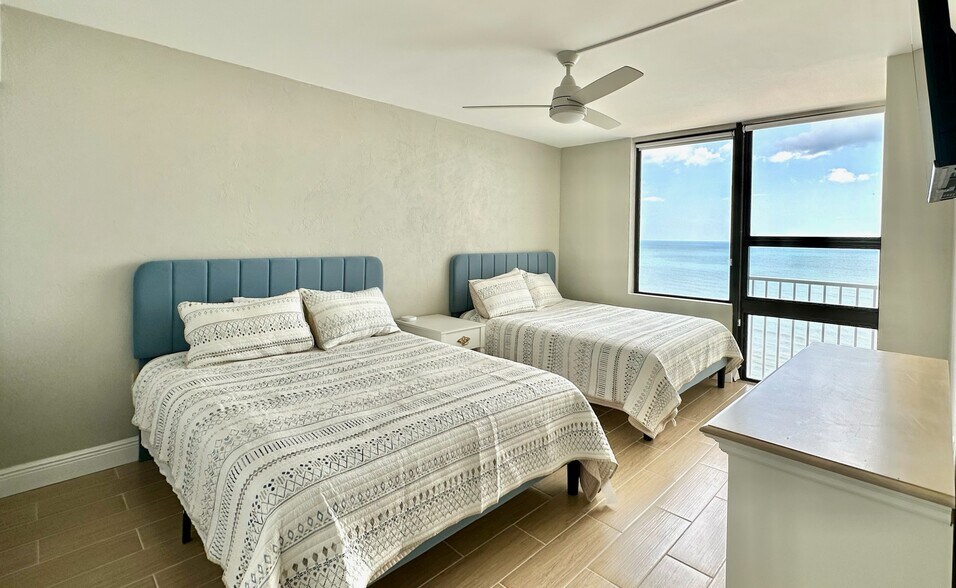 Guest Bedroom with 2 queens, 50" smart tv, and direct ocean view - 3043 S Atlantic Ave