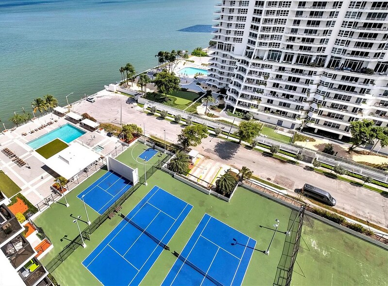 Tennis courts, basketball court, pool, hot tub, club room as viewed from the balcony - 600 NE 36th St