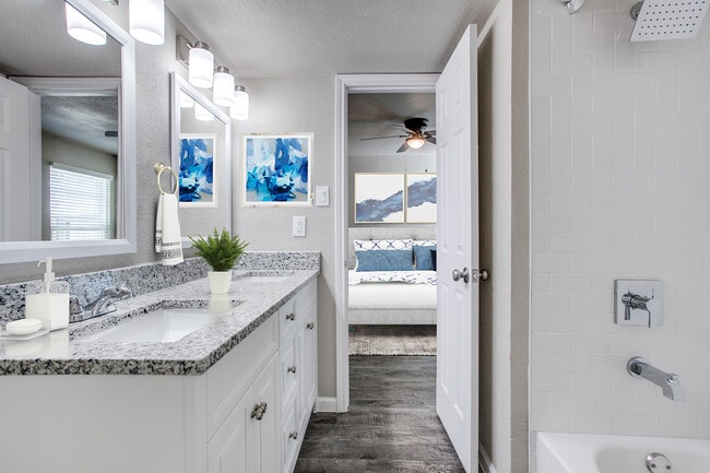 Every residence has granite counters, framed mirrors and designer tile shower/tub surrounds. - The Patios of McKinney