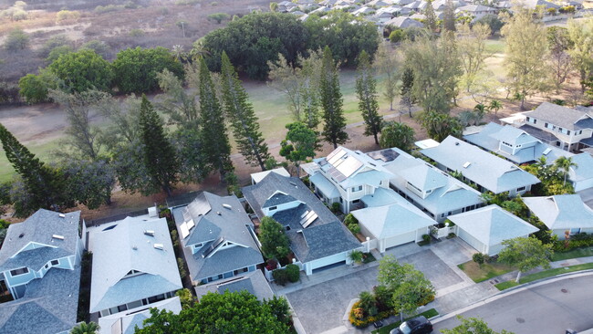 Golf course frontage with Norfolk pines, bougainvillea and tropical flowers - 353 Holokai Pl