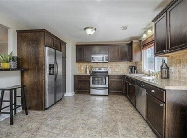 Building Photo - {5611} Updated OP Ranch + Two Car Garage + Fenced Yard and Stamped Concrete Patio Perfect for Spr...