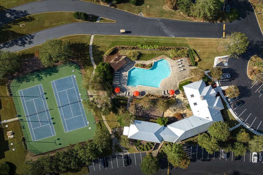 Experience upscale living with top-notch amenities including a pristine pool and tennis courts. - District at Hamilton Place